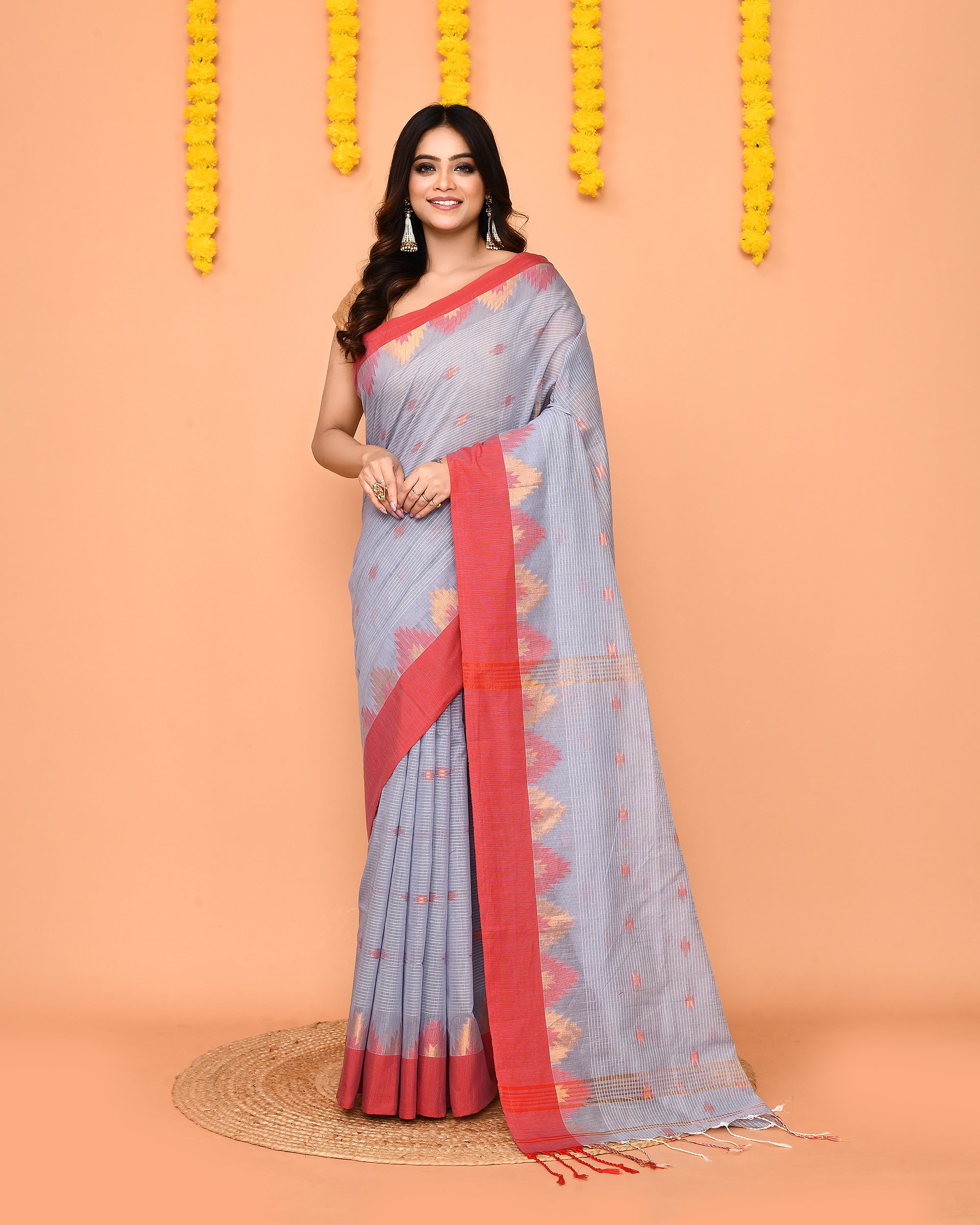 Sky blue cotton blend saree featuring a contrasting red temple border