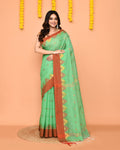 Green handloom cotton blend saree with a contrasting red temple border