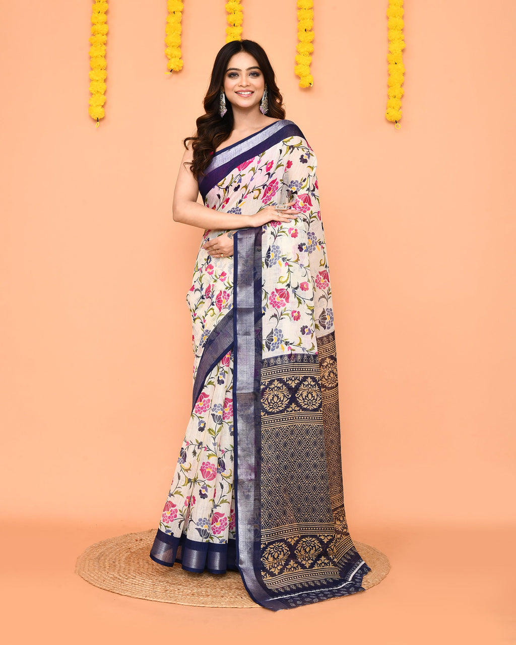Off White printed cotton saree with a red zari border draped elegantly