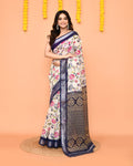 Off White printed cotton saree with a red zari border draped elegantly