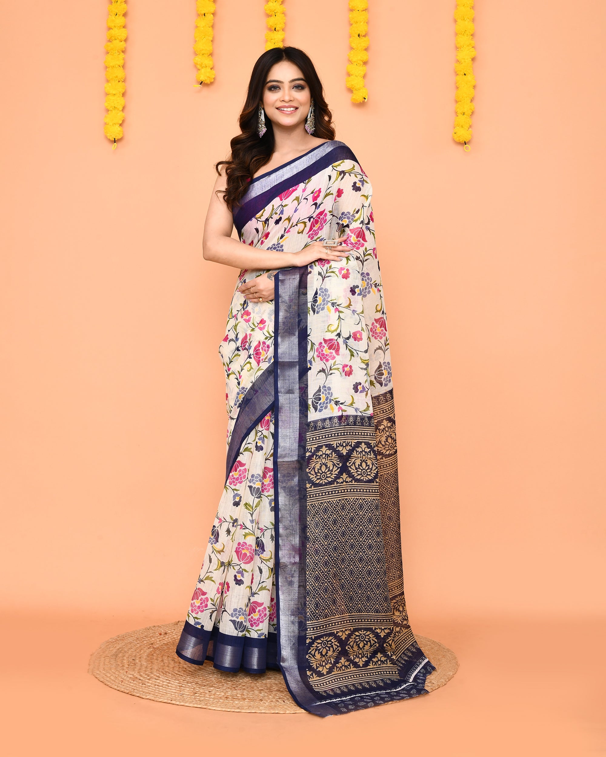 Off White printed cotton saree with a red zari border draped elegantly