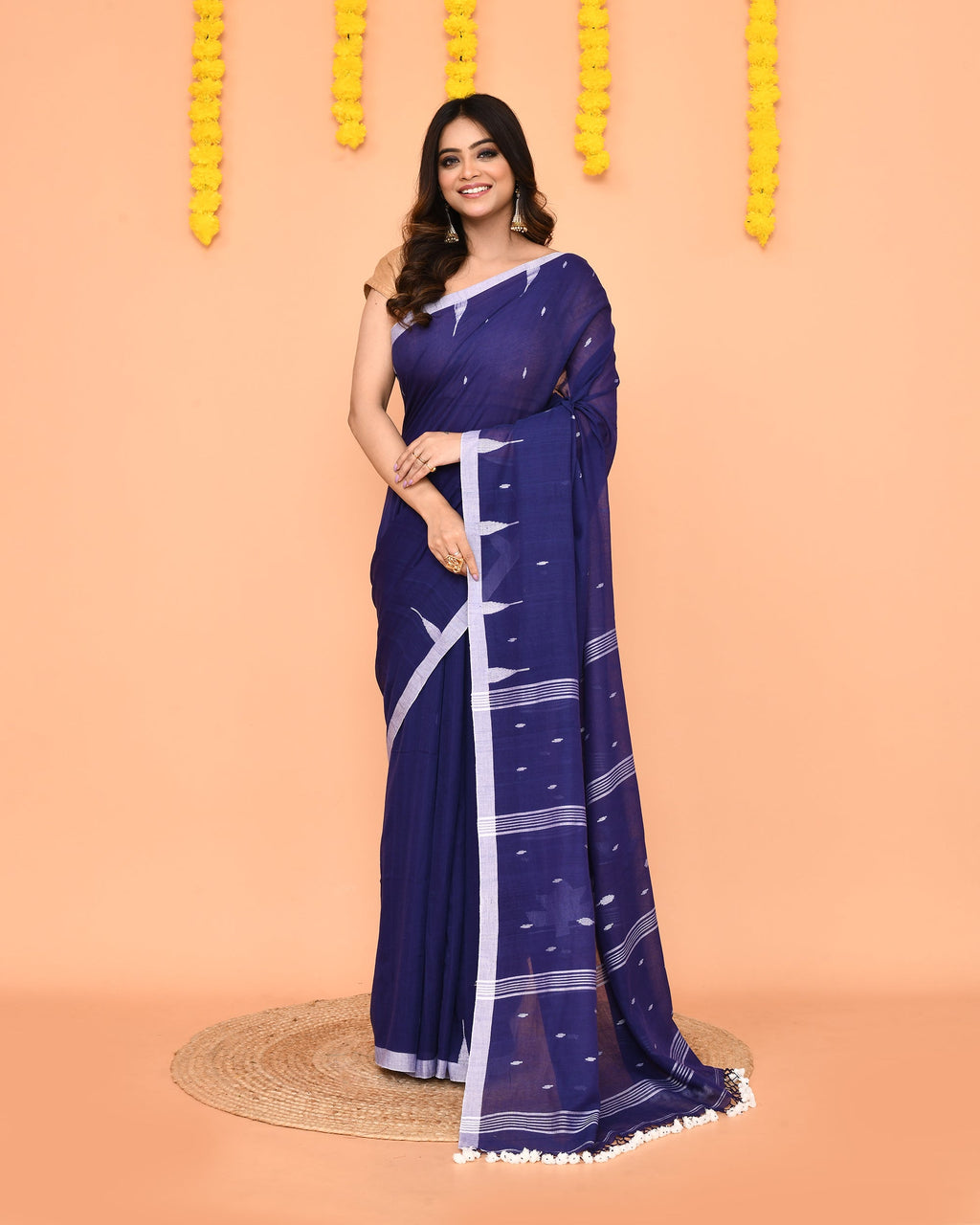 Soft blue Mul cotton Jamdani saree featuring net tassels and traditional weave.
