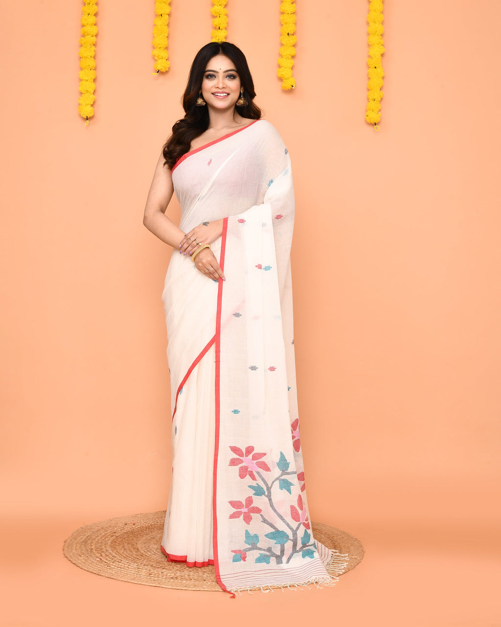 Classic white pure cotton handloom Jamdani saree with intricate weaving details.