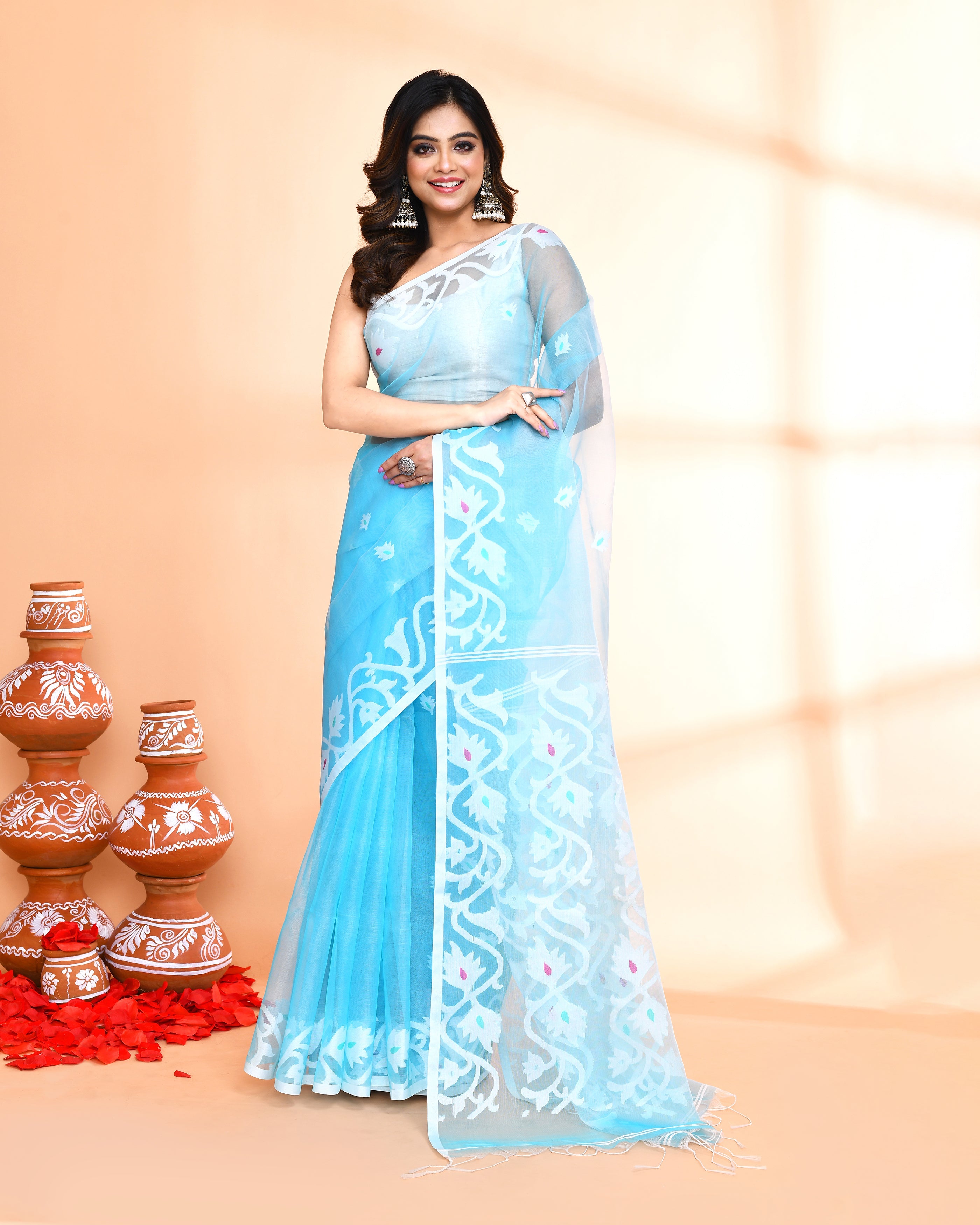 An elegant aqua-colored Art Silk Jamdani saree featuring detailed hand work.