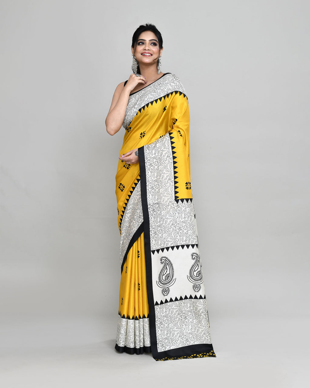 Model wearing a golden printed silk blend saree with matching blouse, featuring an elegant festive design.