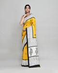 Model wearing a golden printed silk blend saree with matching blouse, featuring an elegant festive design.