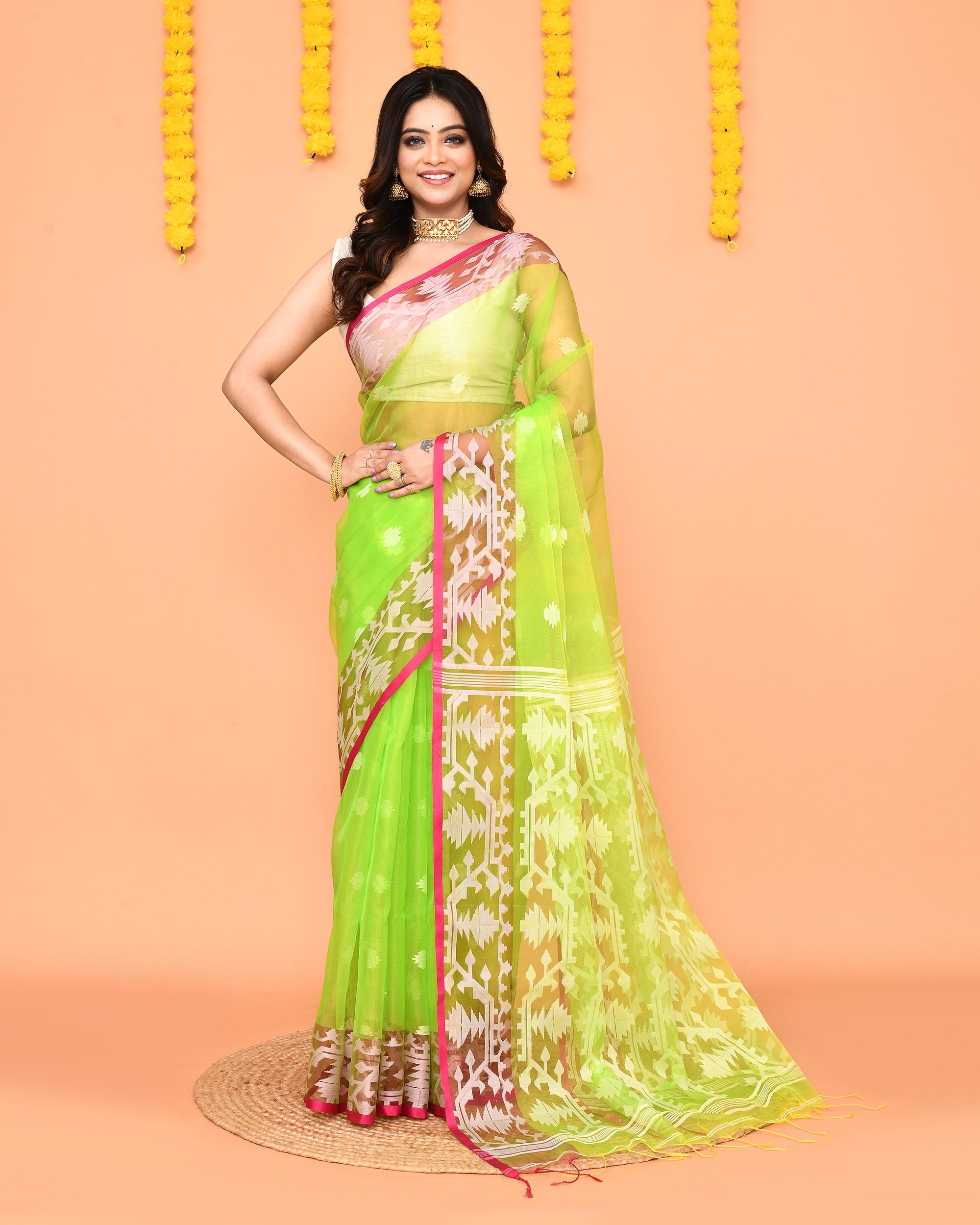 Lime green Resham silk Jamdani saree featuring an intricate vibrant red border.