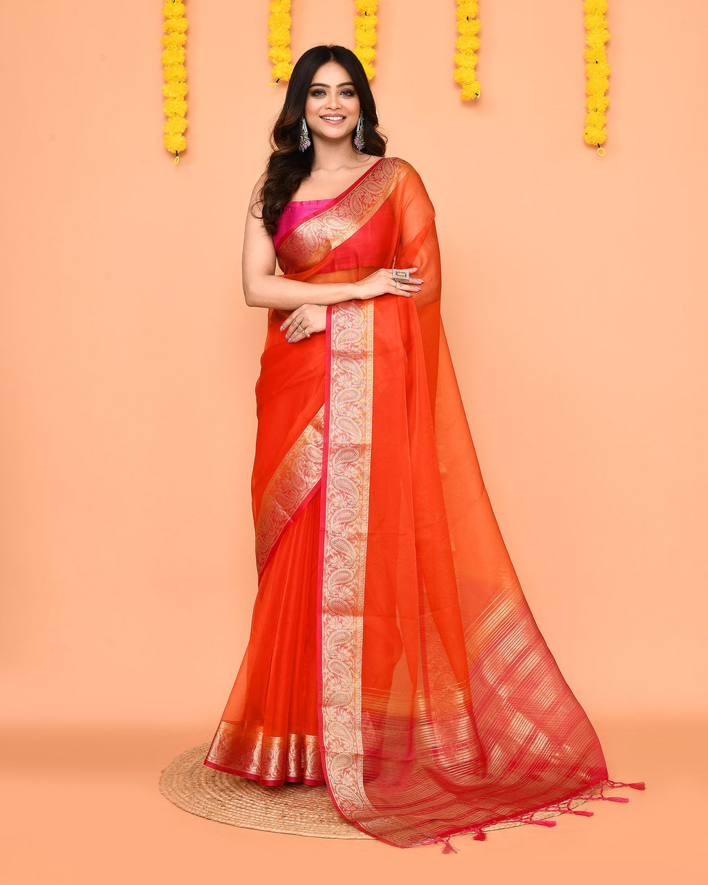 Orange organza silk saree with shimmering Zari border