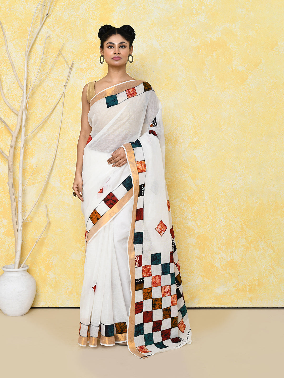Exclusive white saree featuring delicate applique work and a matching blouse.