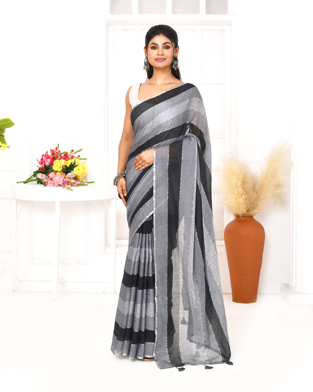 Grey and black striped mulmul cotton saree with decorative tassels on pallu