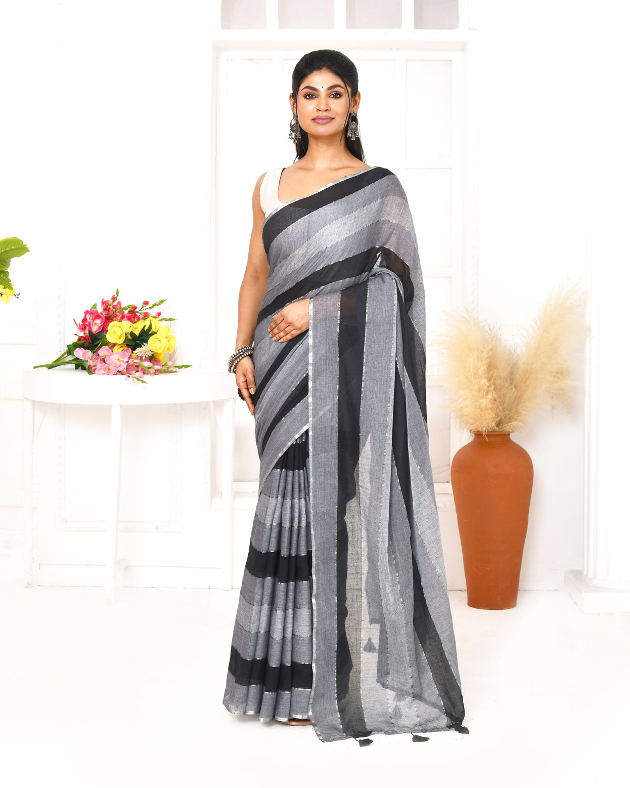Grey and black striped mulmul cotton saree with decorative tassels on pallu