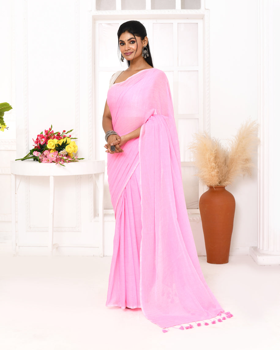 Pink mulmul cotton saree with decorative tassels on the pallu