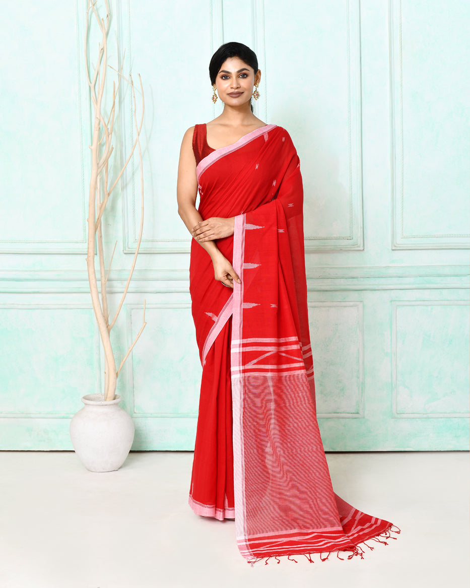 Vibrant red cotton handloom Jamdani saree with intricate weaving and matching blouse piece.