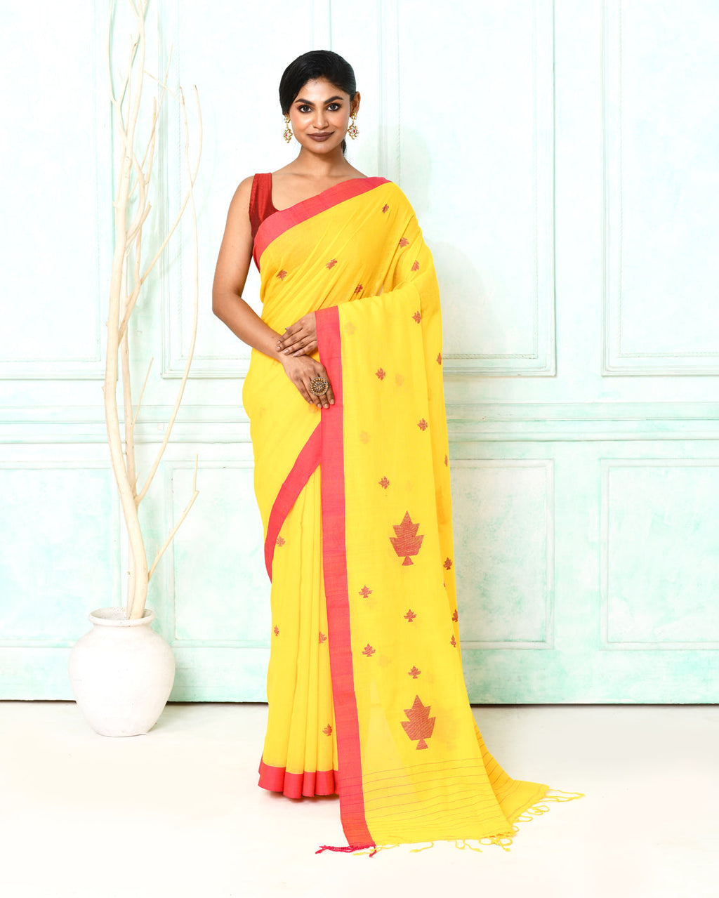 Bright yellow cotton handspun Jamdani saree with detailed handloom patterns.