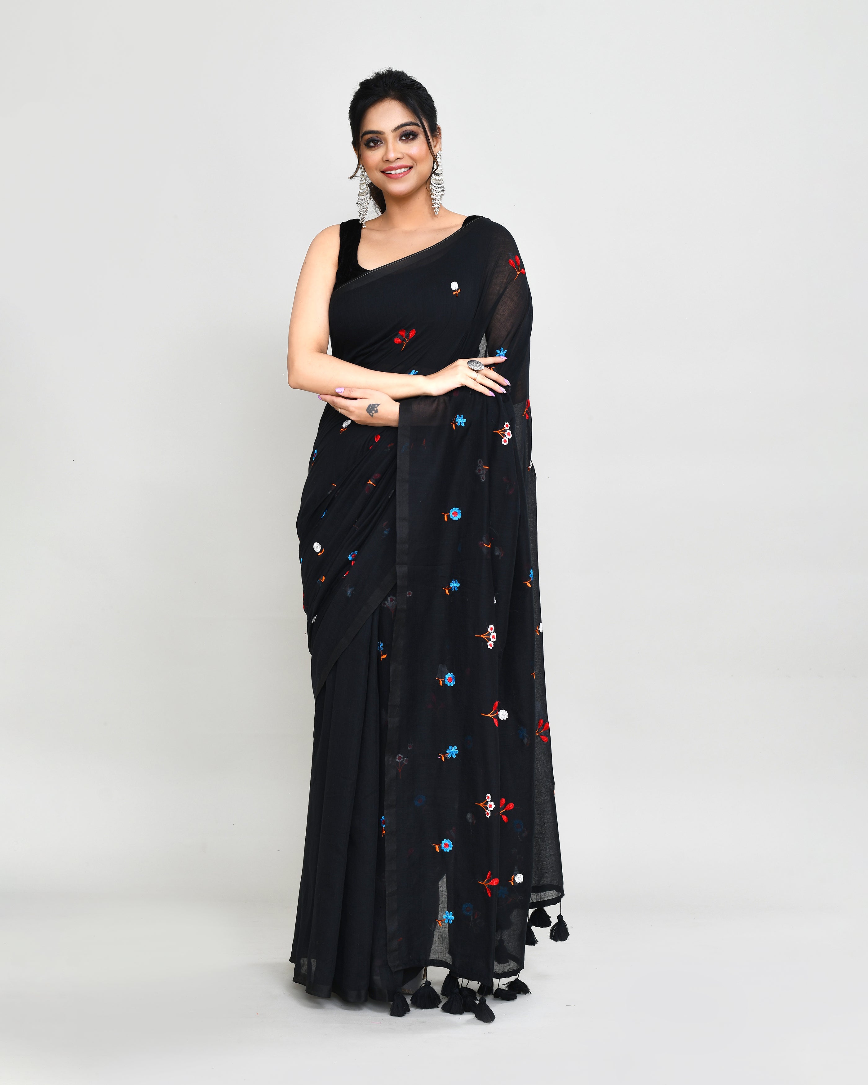 Black exclusive embroidered saree with detailed tassel embellishments on the pallu.