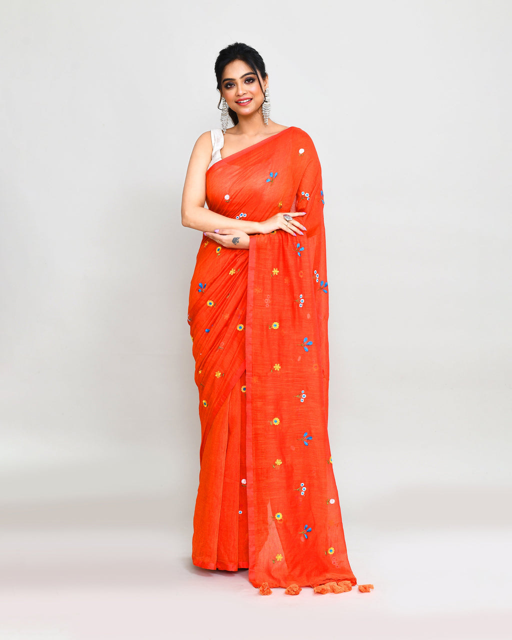 Orange red dual-tone handspun cotton saree with intricate embroidery and tassels