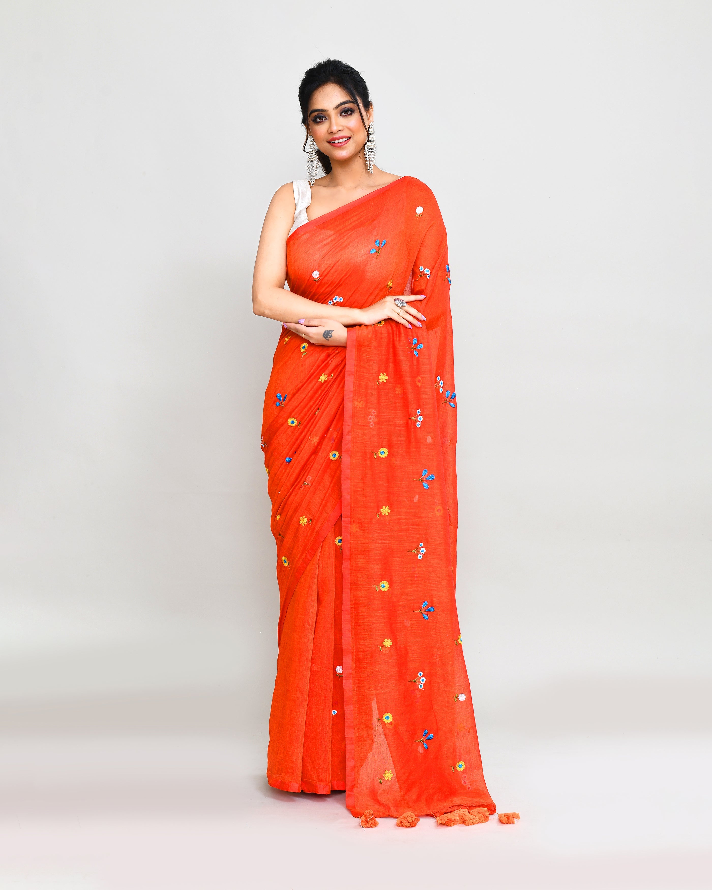 Orange red dual-tone handspun cotton saree with intricate embroidery and tassels