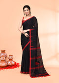 Woman wearing a black handloom Jamdani saree with intricate detailing and matching blouse