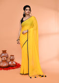Vibrant Yellow Mulmul Cotton saree featuring elegant tassel details