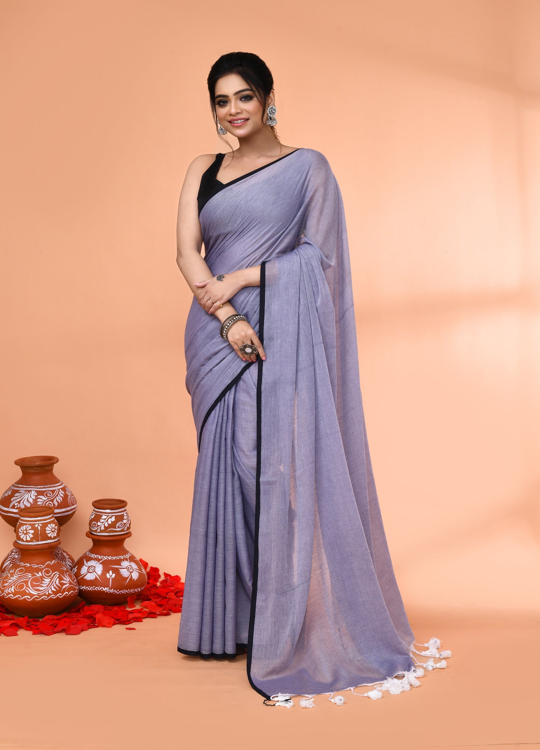 Grey Mulmul cotton saree with decorative tassels draped elegantly