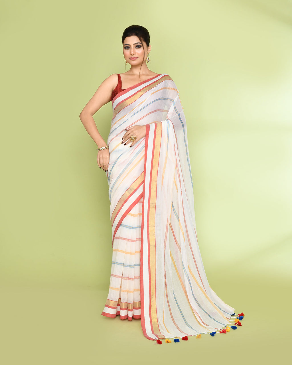 White cotton saree with intricate embellishments and a classic checked pattern