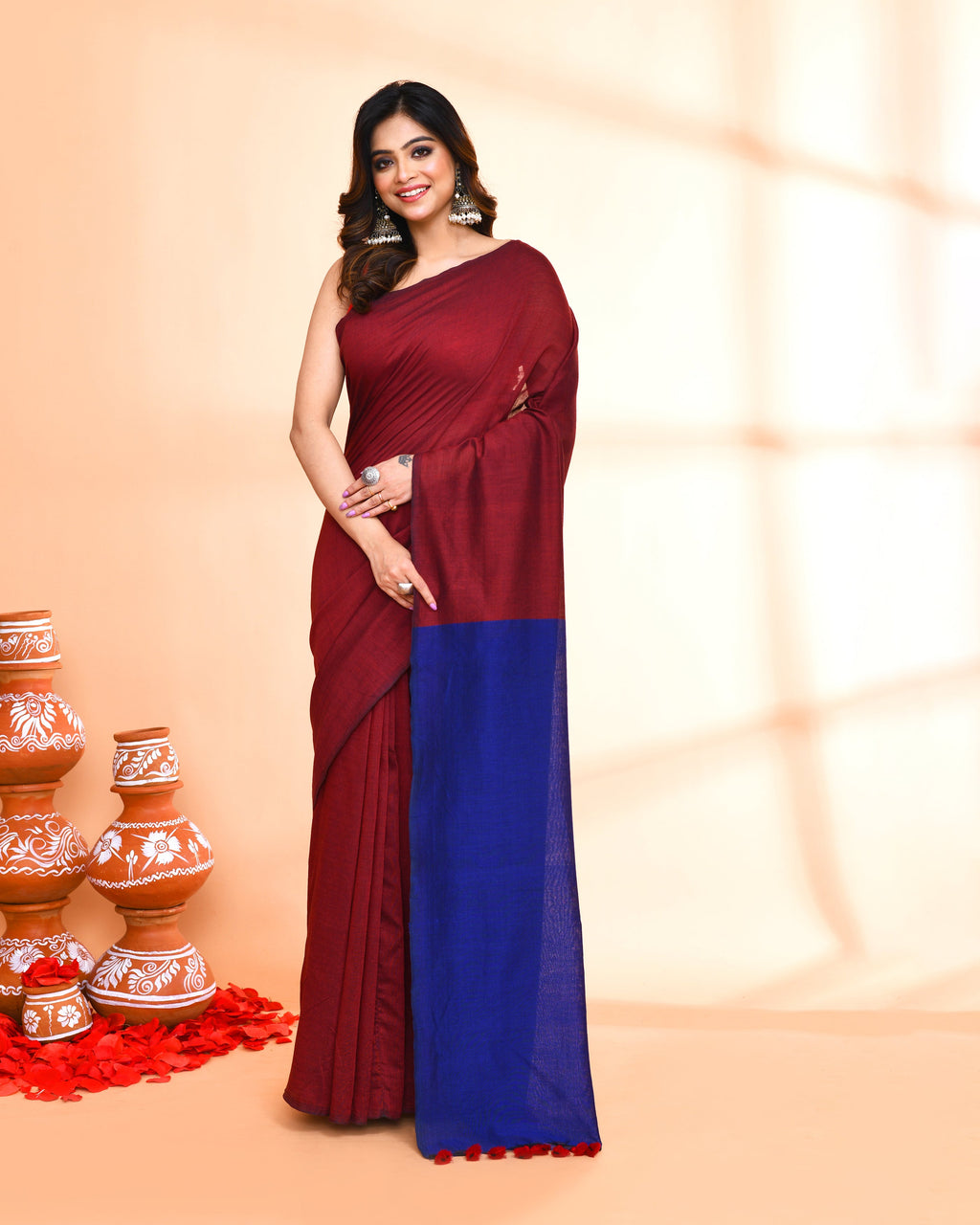 A sophisticated maroon handspun cotton handloom saree with a matching blouse piece.
