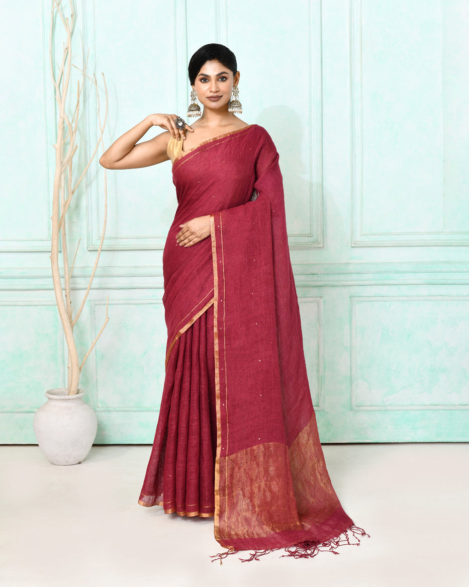 Elegant maroon handloom linen saree with sequin details and matching blouse