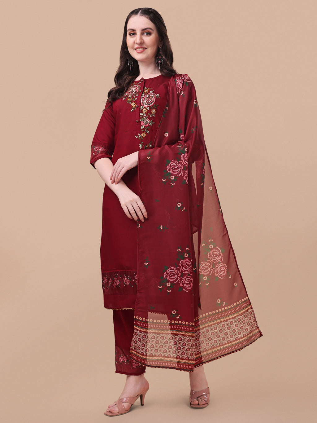 A woman wearing a multicolor embroidered rayon kurta set with matching pants and dupatta.