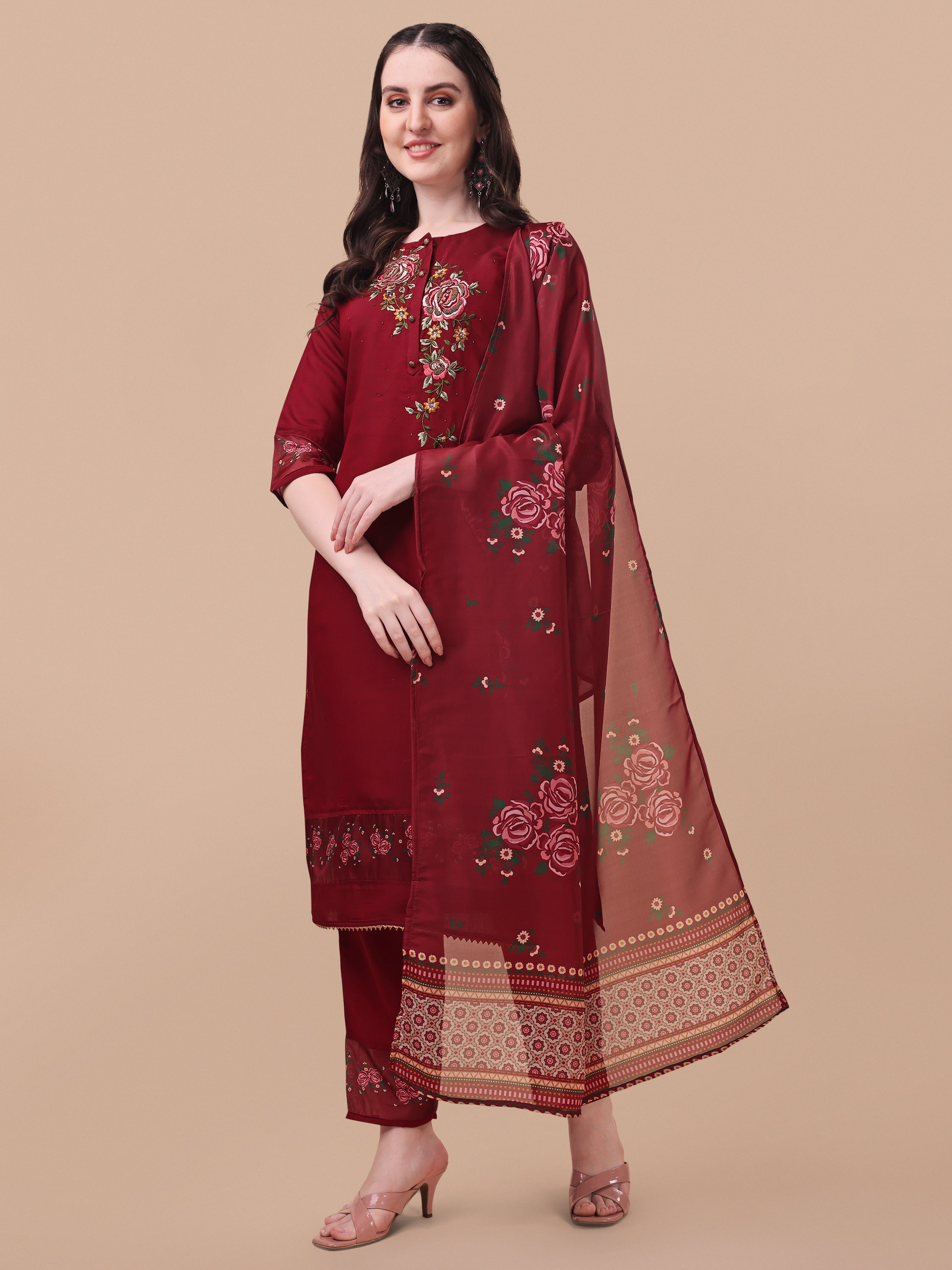 A woman wearing a multicolor embroidered rayon kurta set with matching pants and dupatta.