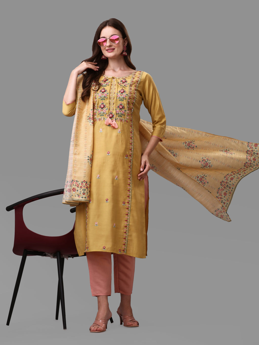 Model wearing a yellow embroidered rayon kurta with matching pants and a dupatta