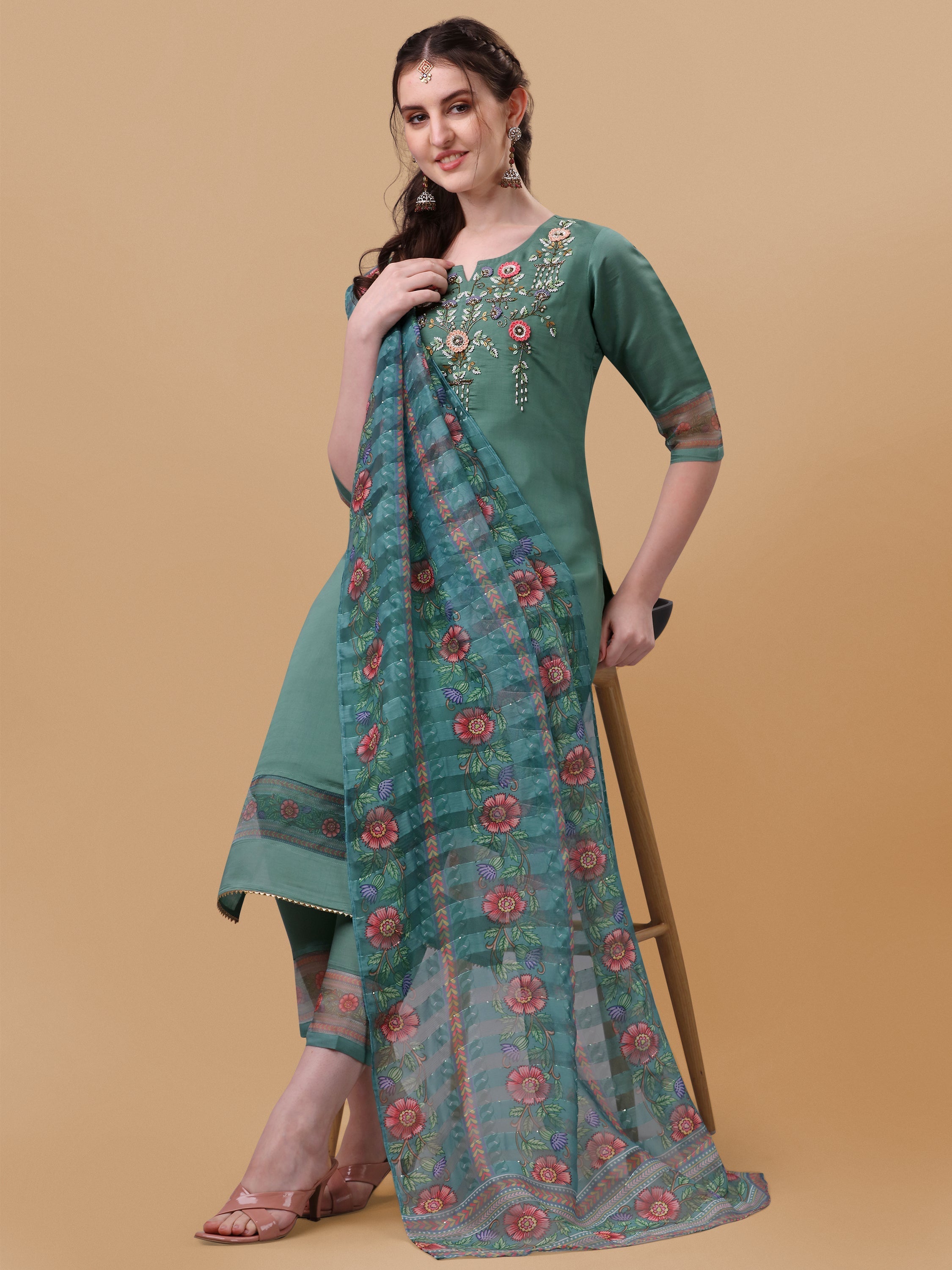 Model wearing a multicolor hand embroidered rayon kurta set with pant and matching dupatta