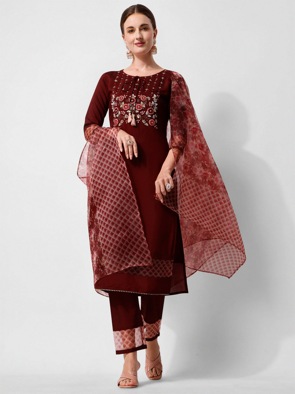 Woman wearing a multicolor hand embroidered rayon kurta set with matching pants and dupatta