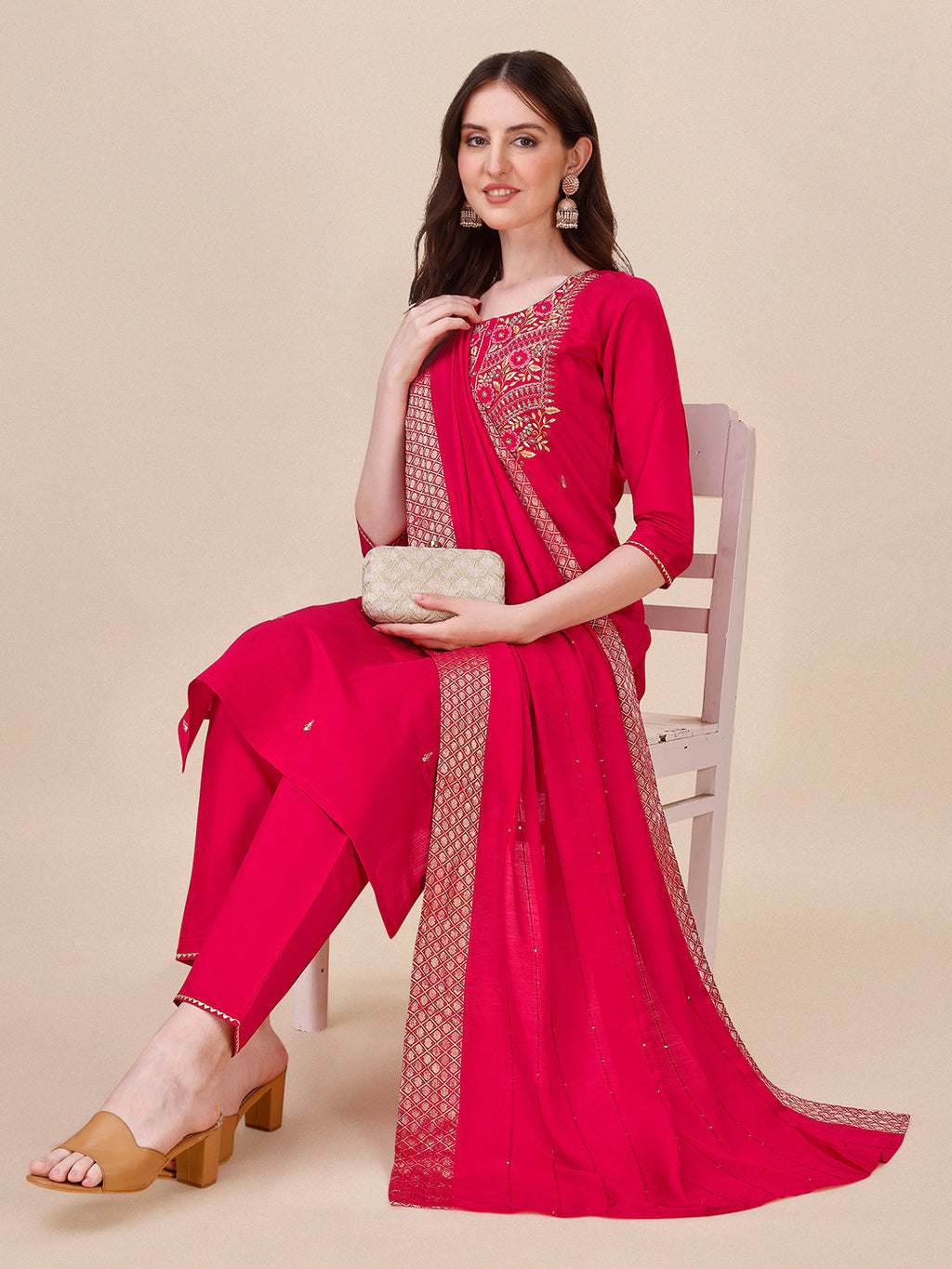 A woman wearing a hot pink Chanderi kurta set with matching pants and a colorful dupatta