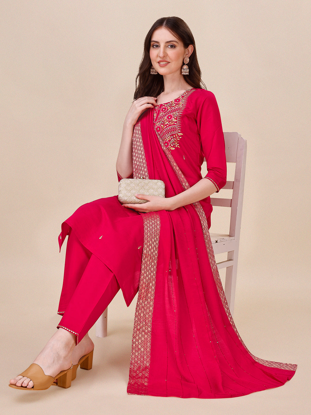 A woman wearing a hot pink Chanderi kurta set with matching pants and a colorful dupatta