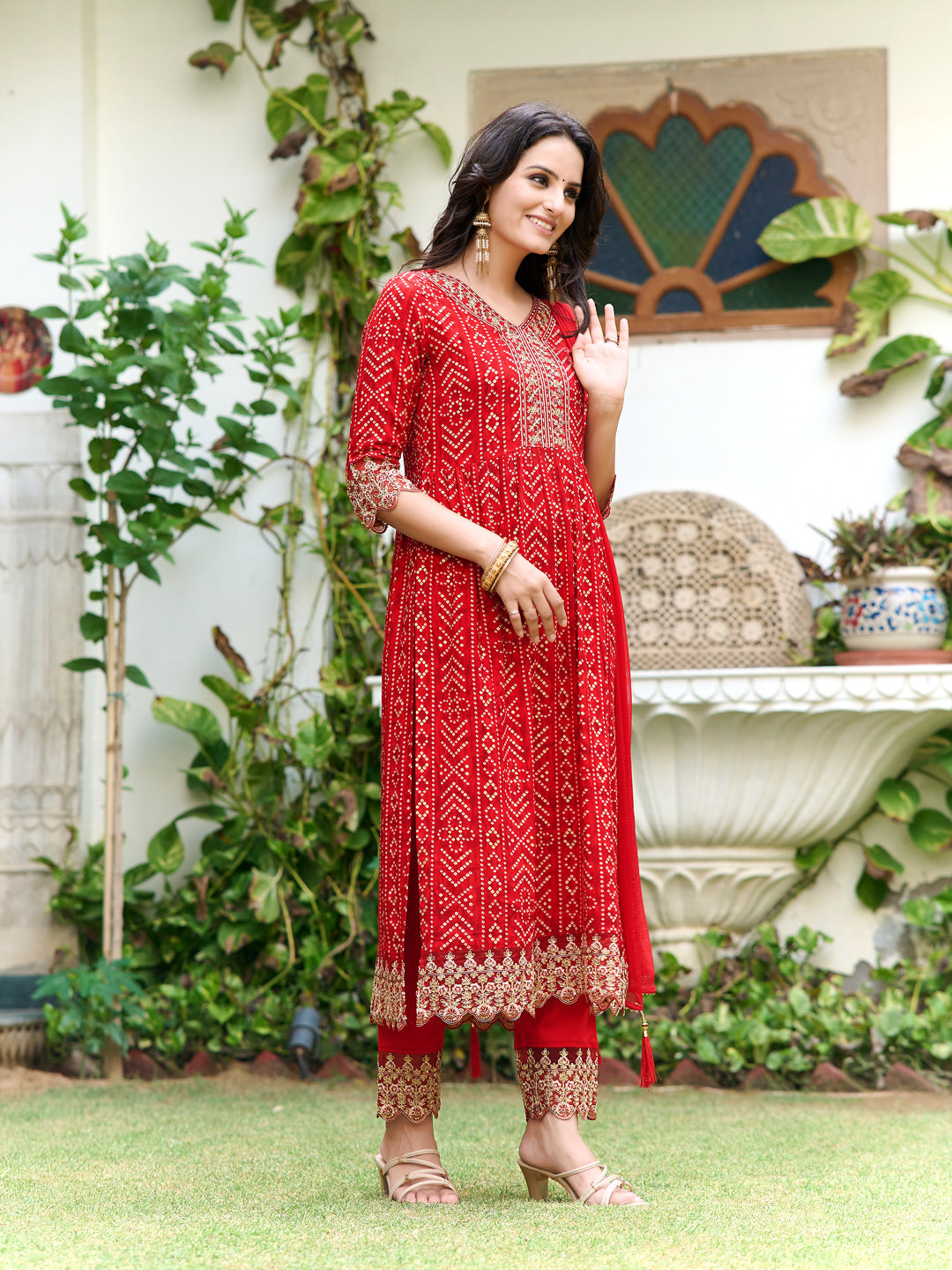 Red Nyra cut kurta with Bandhani print and lace-embroidered pants and dupatta.