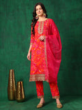 A woman wearing a pink sequined and printed kurta set with an embroidered dupatta and matching pants.