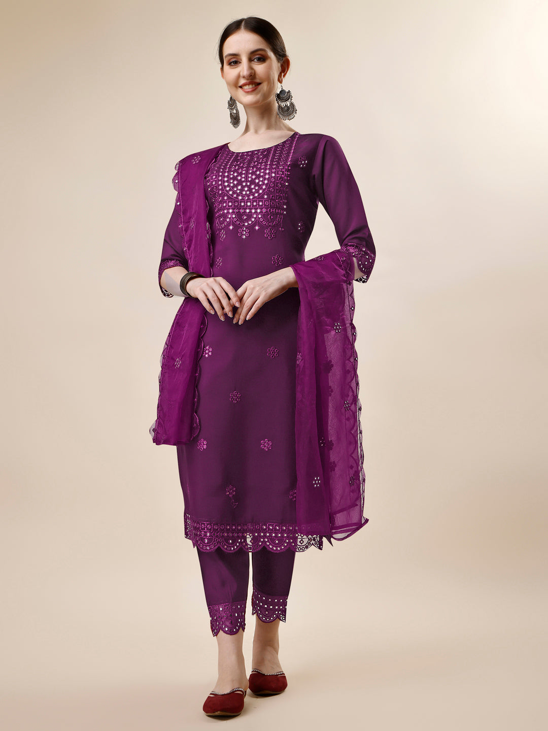 Woman wearing a vibrant multicolor mirror embroidered kurta set with matching pants and dupatta