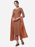 Model wearing a rust-colored rayon kurta set with vibrant floral prints and a matching dupatta