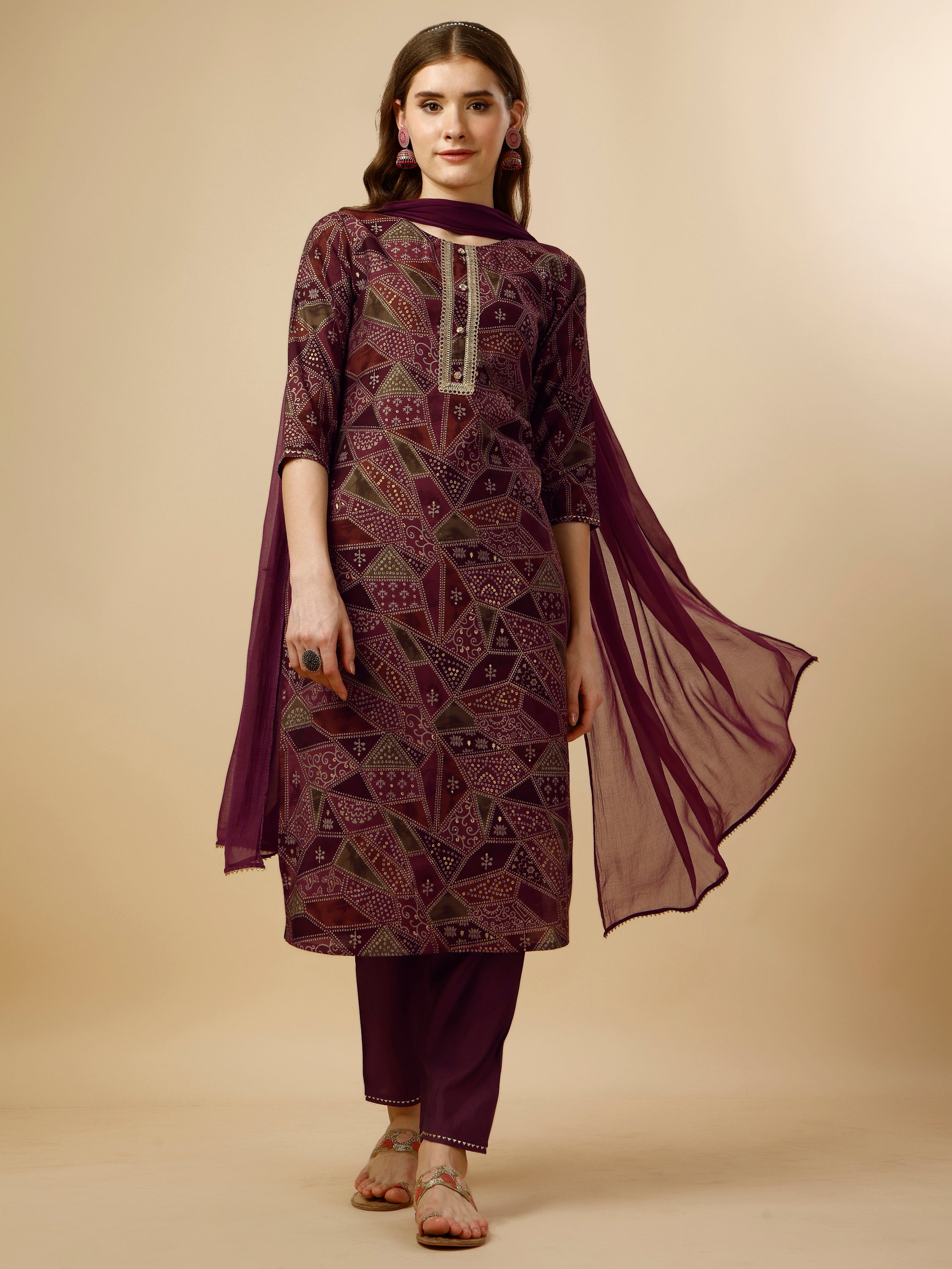 A woman wearing a vibrant multicolor printed kurta set with matching pants and a dupatta
