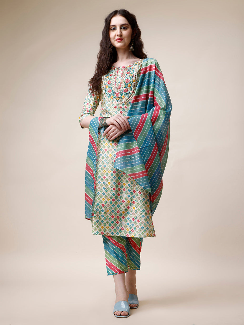 Woman wearing a multicolor ethnic motif printed and embroidered kurta set with matching dupatta.