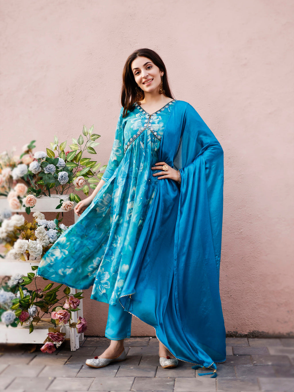 Model wearing a multicolor Alia cut hand embroidered and floral printed kurta set with matching pant and dupatta.