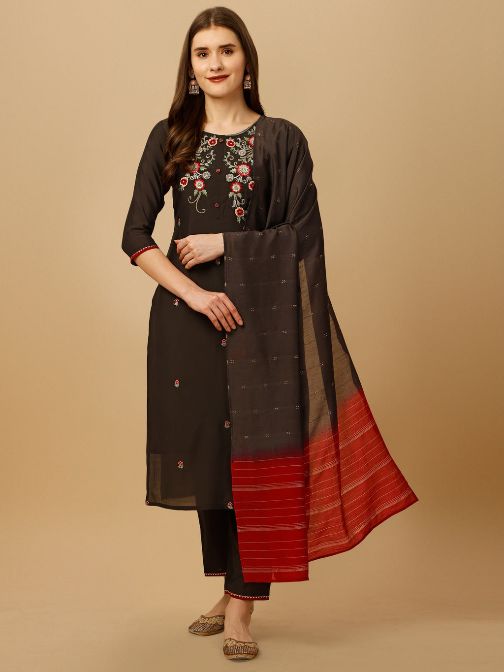 Woman wearing a multicolor hand embroidered kurta set with matching pant and dupatta