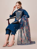 A woman wearing a vibrant multicolor hand-embroidered kurta with matching pant and dupatta set.