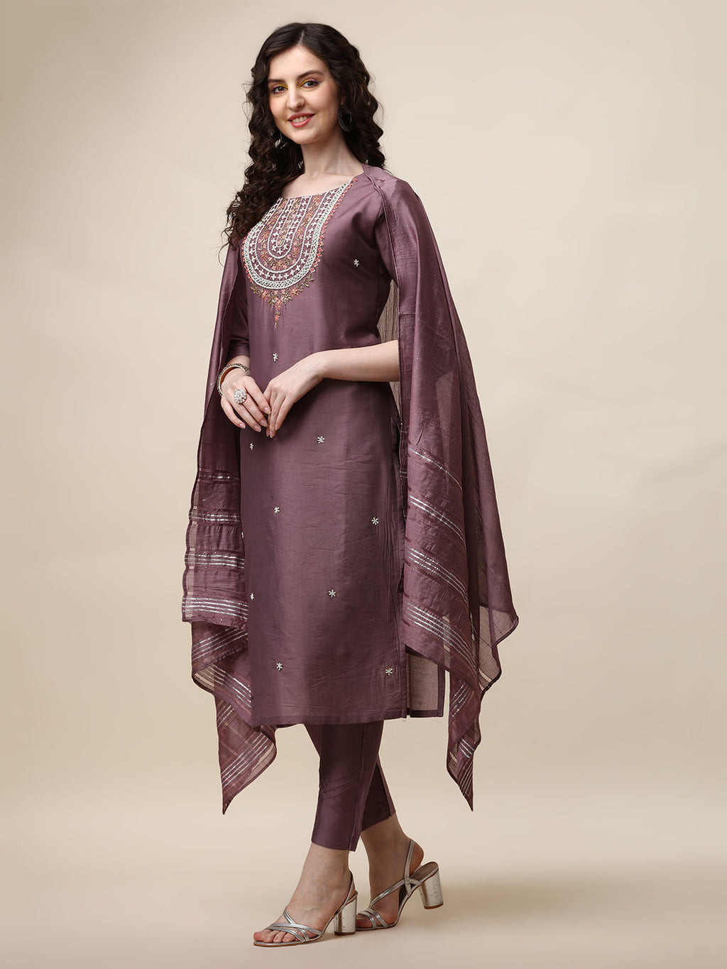 Model wearing a multicolor embroidered lavender kurta with matching pants and a dupatta.
