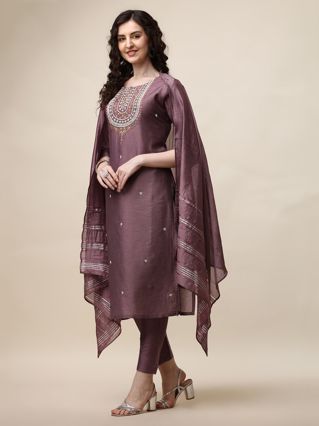 Model wearing a multicolor embroidered lavender kurta with matching pants and a dupatta.