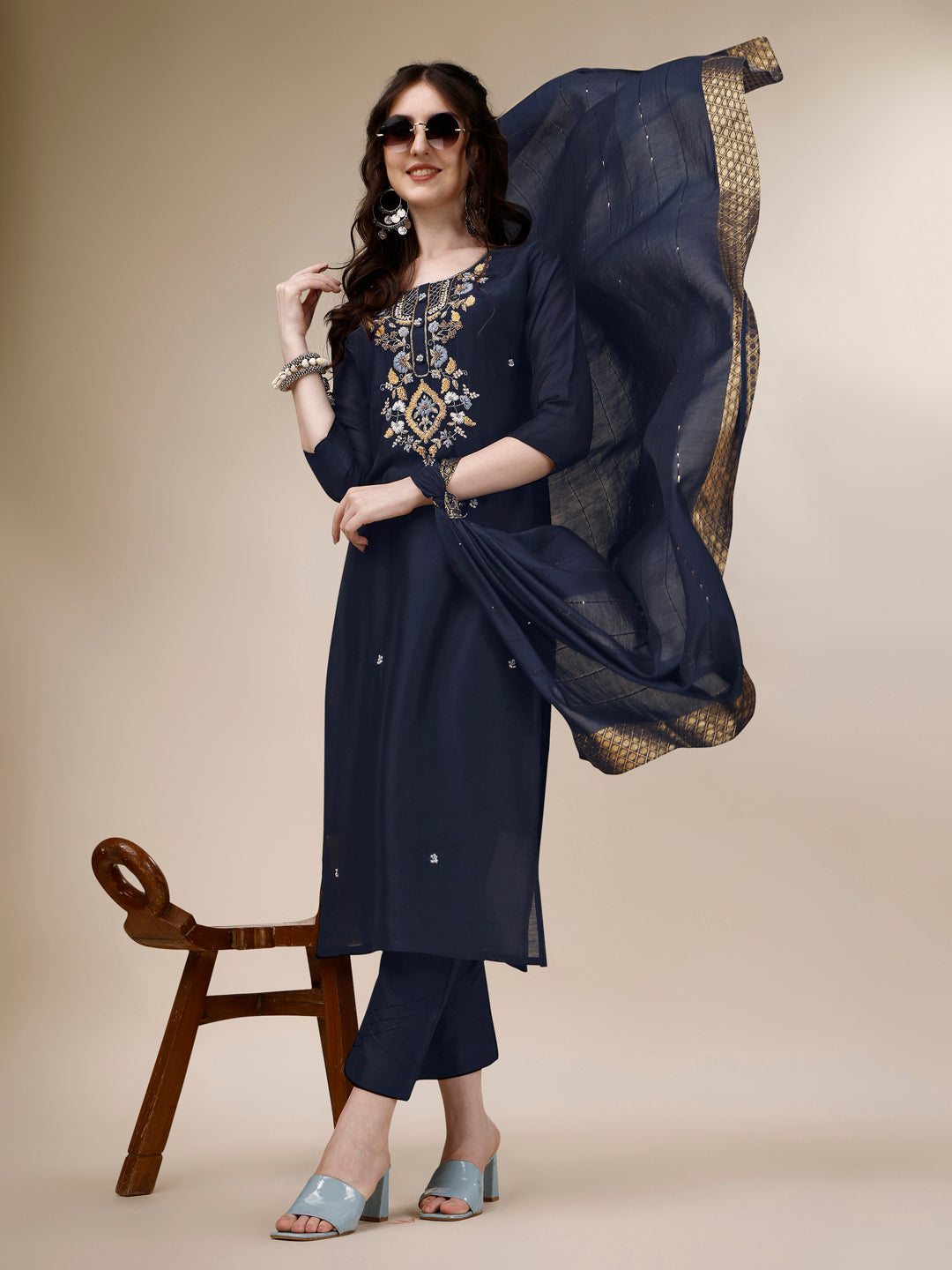 Model wearing a multicolor embroidered rayon kurta paired with matching pants and a dupatta