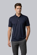 Model wearing a navy blue short sleeve UPF 50 performance polo shirt
