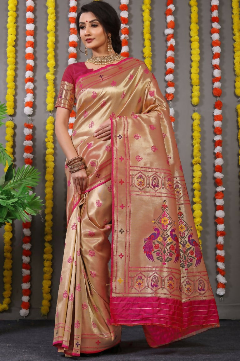 Woman wearing a Rani Pink Paithani Silk Saree with Zari woven border and matching blouse