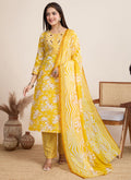 Bright yellow printed cotton blend salwar suit set for festive occasions.