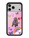 iPhone case featuring a cute puppy graphic against a bright pink background with cherries, stars, rainbows, and butterflies, framed by a black protective bumper.